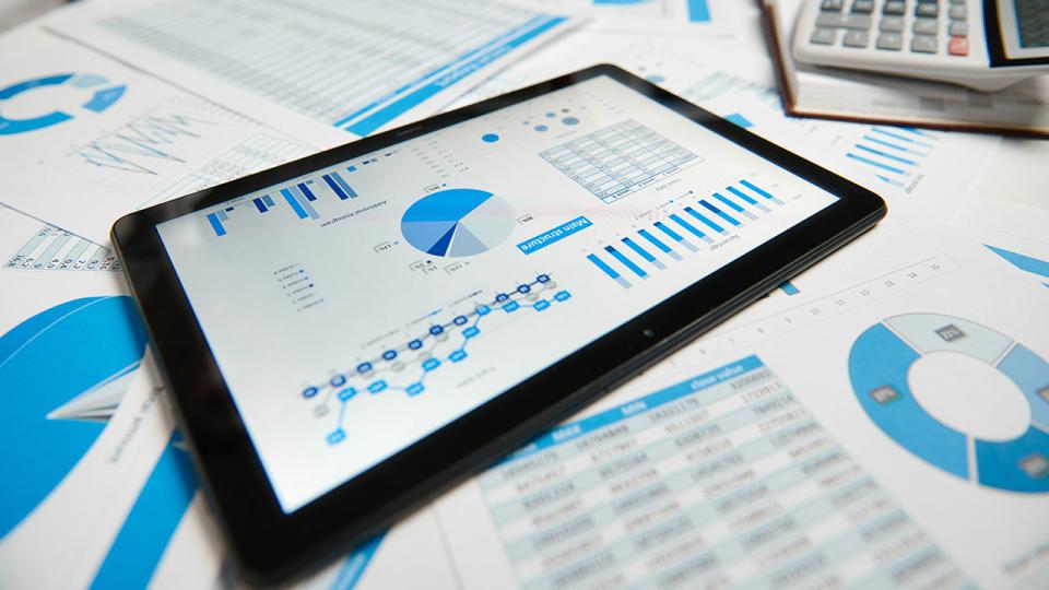 Büroarbeitsplatz für Unternehmen. Tablet-PC und Berichte. Tabelle Nahaufnahme.